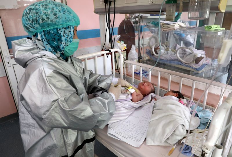 &copy; Reuters. FILE PHOTO: An Afghan nurse observes newborn children who lost their mothers during an attack at a hospital, in Kabul