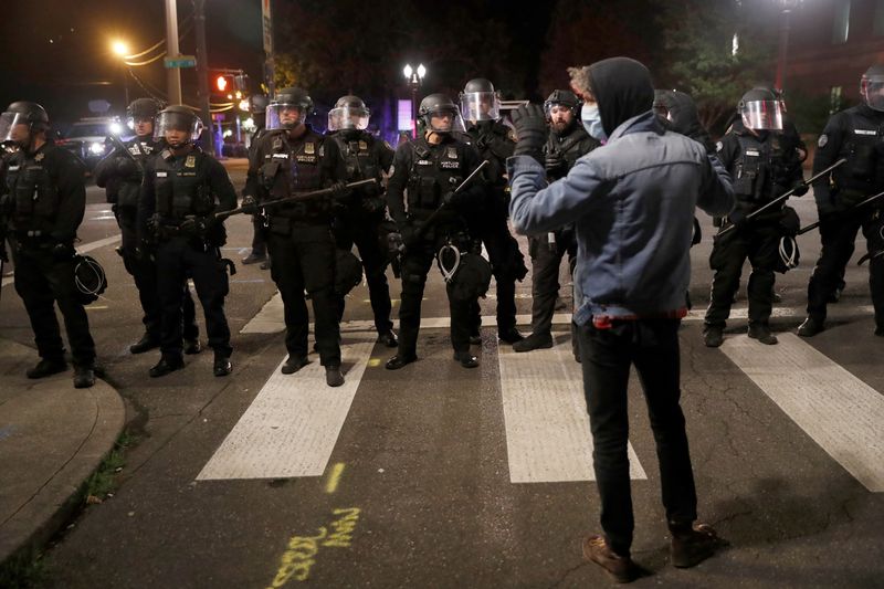 &copy; Reuters. A protester confronts police while rallying against the death in Minneapolis police custody of George Floyd, in Portland