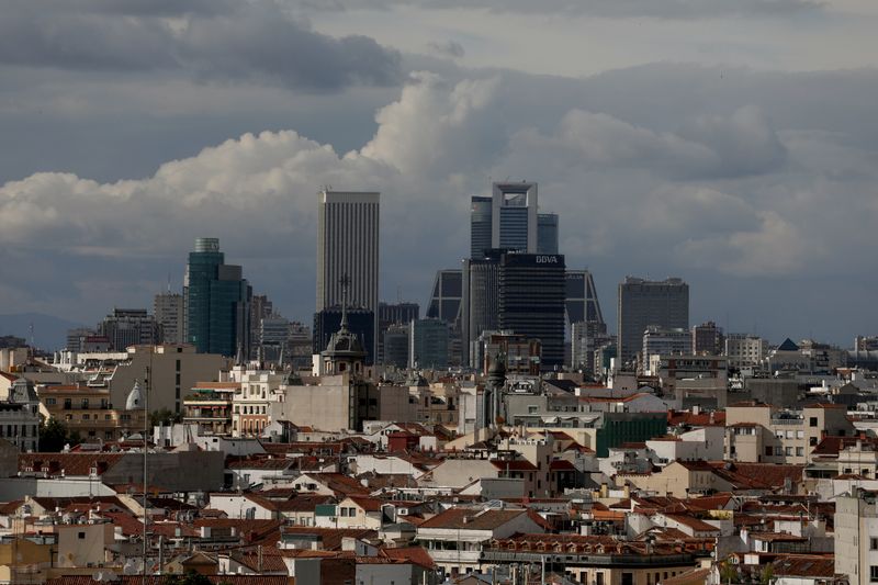 &copy; Reuters. Clouds pass over business district buildings in Madrid