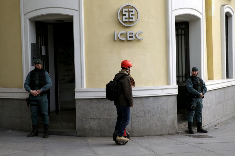 &copy; Reuters. FILE PHOTO: A man rides a segway near Spanish Civil Guards at the headquarters of Industrial and Commercial Bank of China (ICBC) during a raid in Madrid