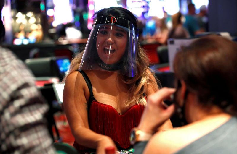 &copy; Reuters. FILE PHOTO: A blackjack dealer wears a face shield during the reopening of The D hotel-casino, closed by the state since March 18, 2020 as part of steps to slow the spread of the coronavirus disease (COVID-19), in downtown Las Vegas