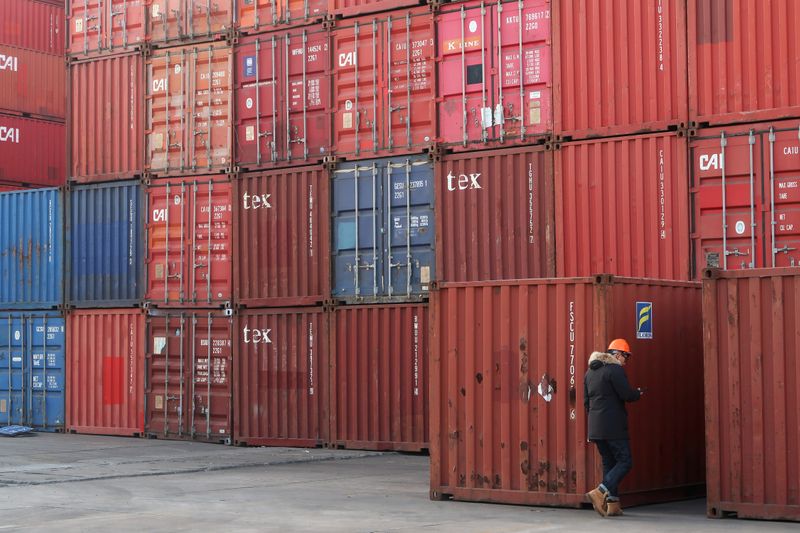 &copy; Reuters. FILE PHOTO: Worker checks containers at a logistics center near Tianjin port