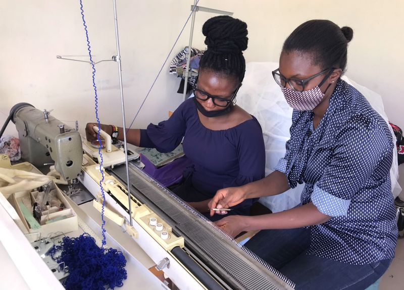 &copy; Reuters. Fadero, a biochemistry graduate is taught how to knit by Kuju at Lungi barracks, as COVID-19 infections continue to rise in Abuja