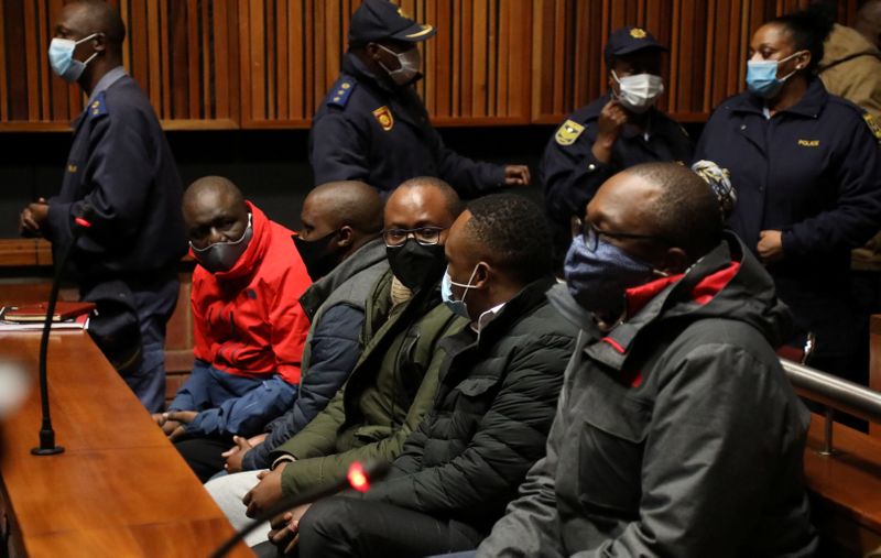 &copy; Reuters. Some of the eight people suspected of VBS Mutual Bank fraud case appear at the Palm Ridge Regional Court in Alberton