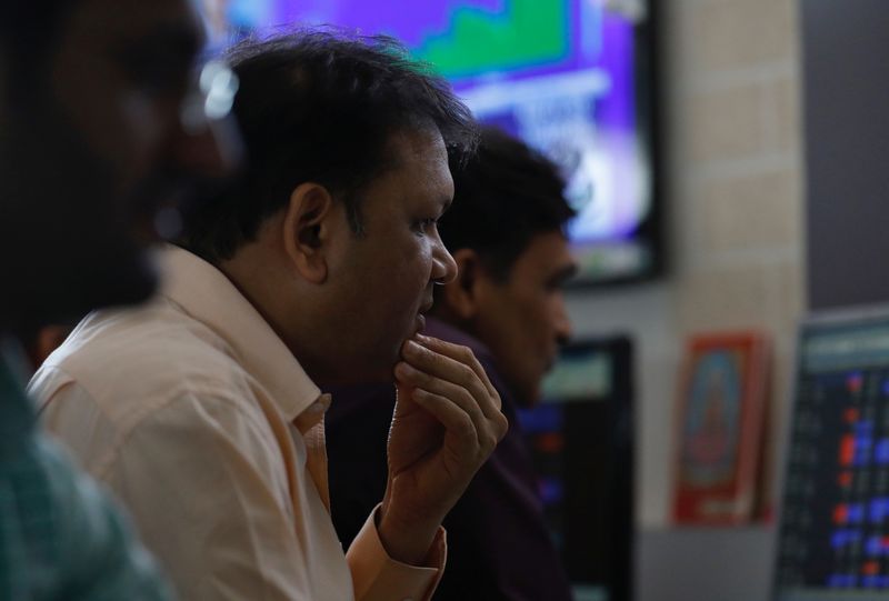 © Reuters. A broker reacts while trading at his computer terminal at a stock brokerage firm in Mumbai