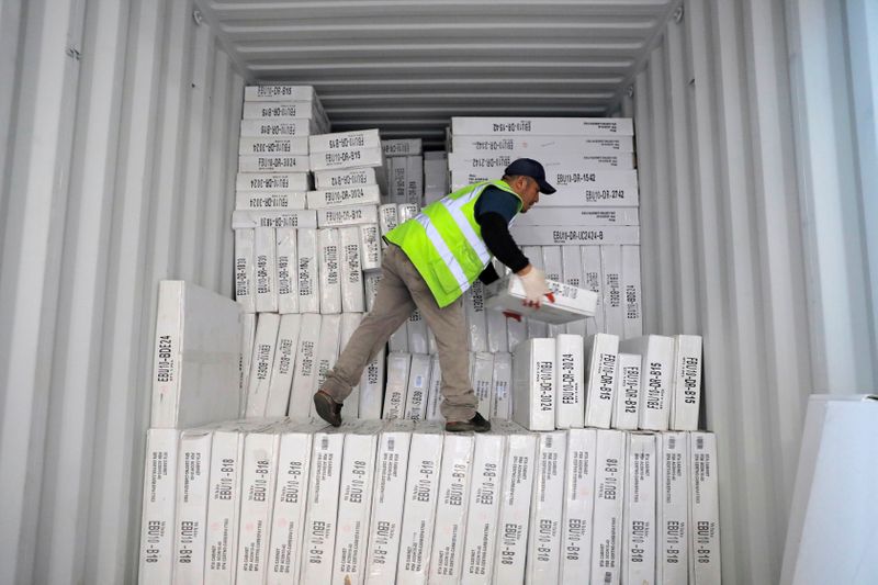 © Reuters. FILE PHOTO: A worker unloads a delivery from Indonesia CNC Cabinetry in South Plainfield, New Jersey