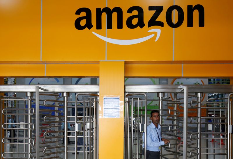 © Reuters. An employee of Amazon walks through a turnstile gate inside an Amazon Fulfillment Centre (BLR7) on the outskirts of Bengaluru