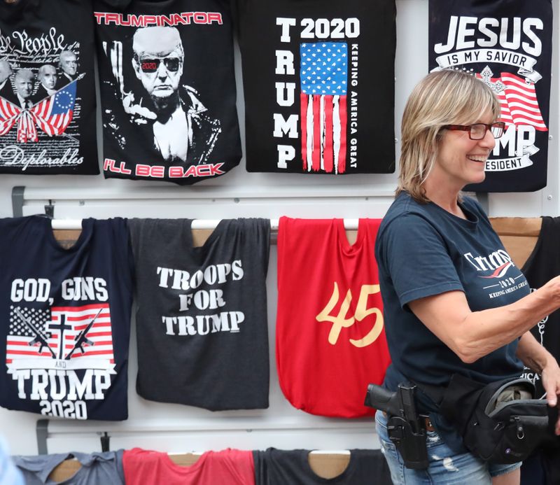 &copy; Reuters. A woman sells T-shirts near the BOK Center in Tulsa
