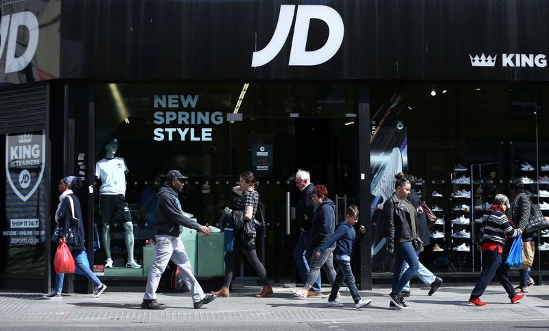 © Reuters. FILE PHOTO: People pass a JD Sports store in London