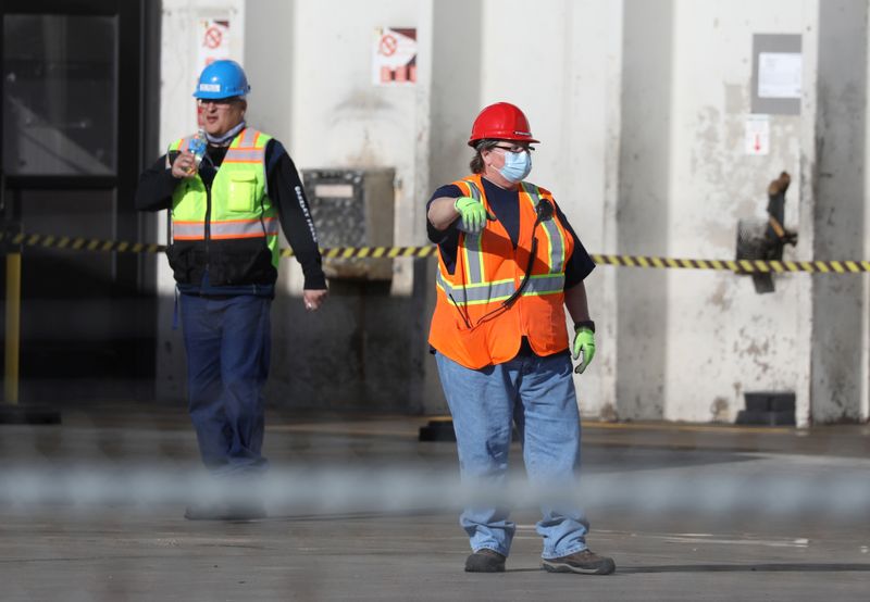 &copy; Reuters. Employees wear face masks at the JBS USA meat packing plant in Greeley