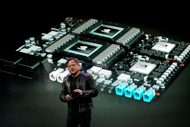 © Reuters. FILE PHOTO: Jensen Huang, CEO of Nvidia, shows the Drive Pegasus robotaxi AI computer at his keynote address at CES in Las Vegas
