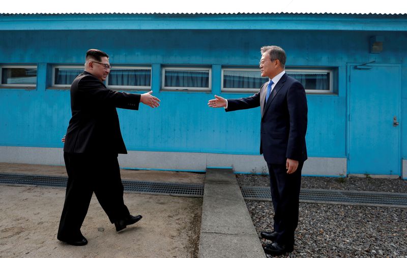 &copy; Reuters. FILE PHOTO: South Korean President Moon Jae-in and North Korean leader Kim Jong Un shake hands at the truce village of Panmunjom