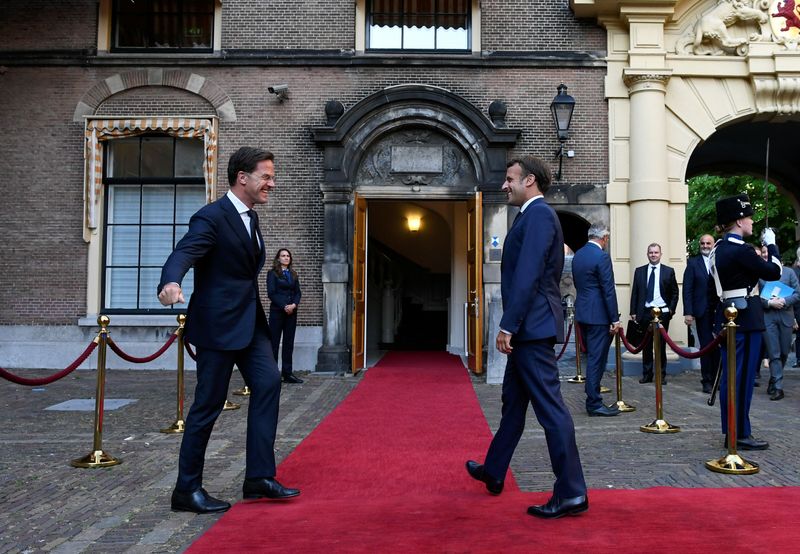 &copy; Reuters. French President Emmanuel Macron and Dutch Prime Minister Mark Rutte react as they arrive for a meeting, in The Hague
