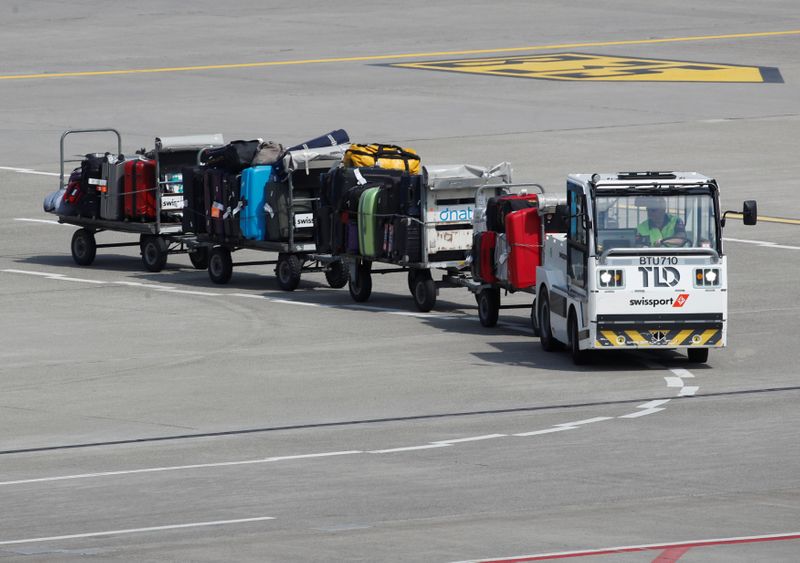 &copy; Reuters. Luggage stored on trolleys is transported by air service provider Swissport at Zurich airport