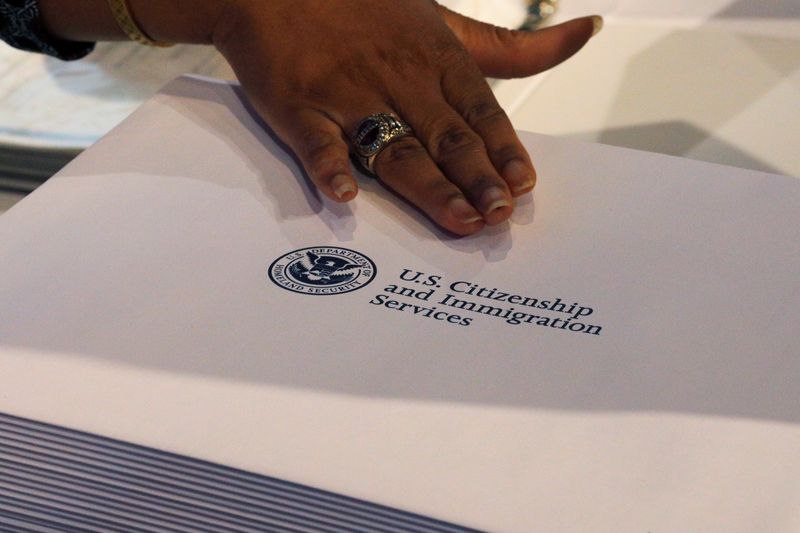 &copy; Reuters. Information packs are distributed by the U.S. Citizenship and Immigration Services following a citizenship ceremony at the John F. Kennedy Presidential Library in Boston