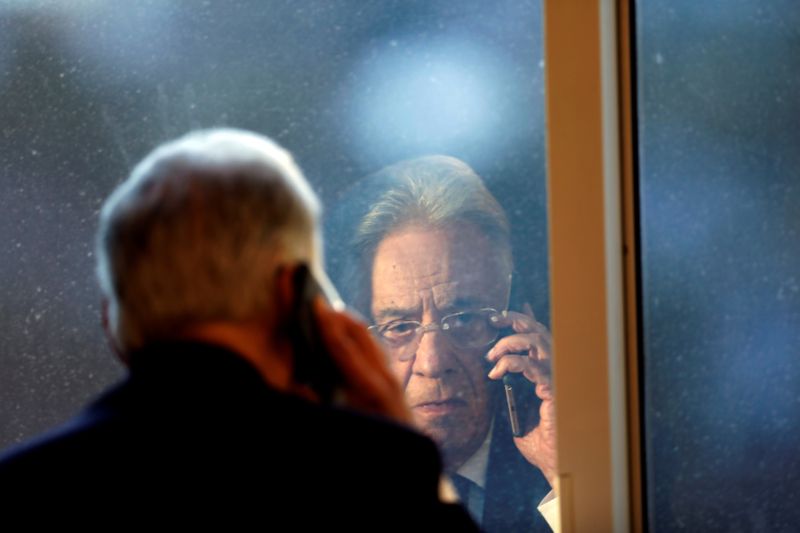 &copy; Reuters. FILE PHOTO: Brazil&apos;s former President Cardoso talks on the phone during an interview with Reuters in Sao Paulo