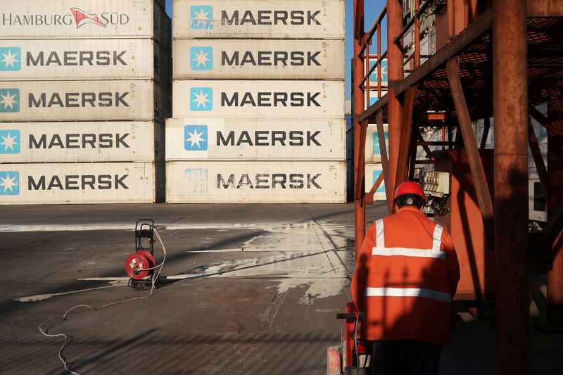 &copy; Reuters. Worker is seen next to Maersk shipping containers at a logistics center near Tianjin por