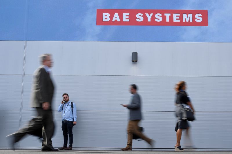 &copy; Reuters. Trade visitors walk past an advertisement for BAE Systems at Farnborough International Airshow in Farnborough, Britain