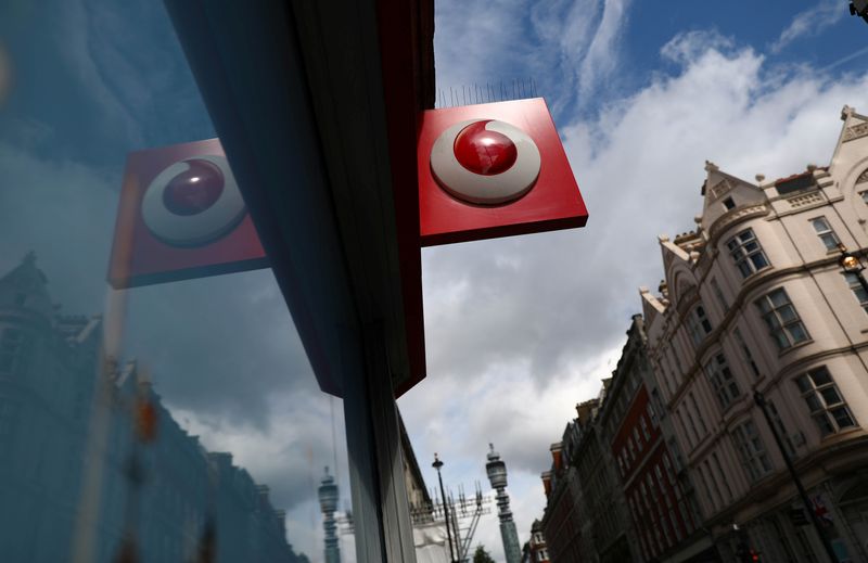 &copy; Reuters. A branded sign is displayed on a Vodafone  store in London
