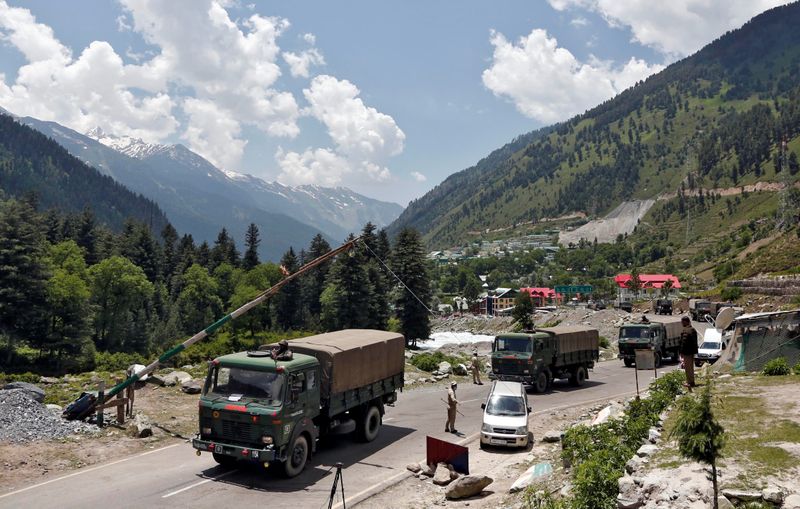 &copy; Reuters. Indian army trucks move along a highway leading to Ladakh, at Gagangeer