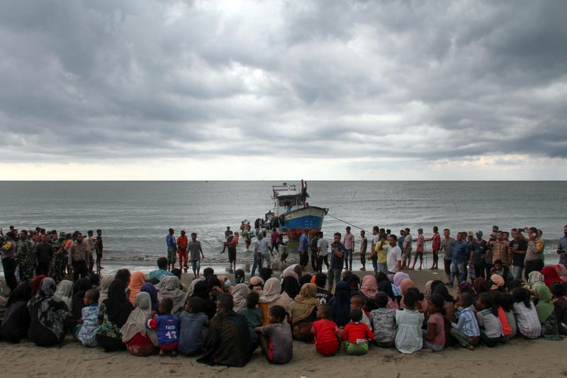 © Reuters. Rohingya refugees are evacuated by locals at a coast of North Aceh