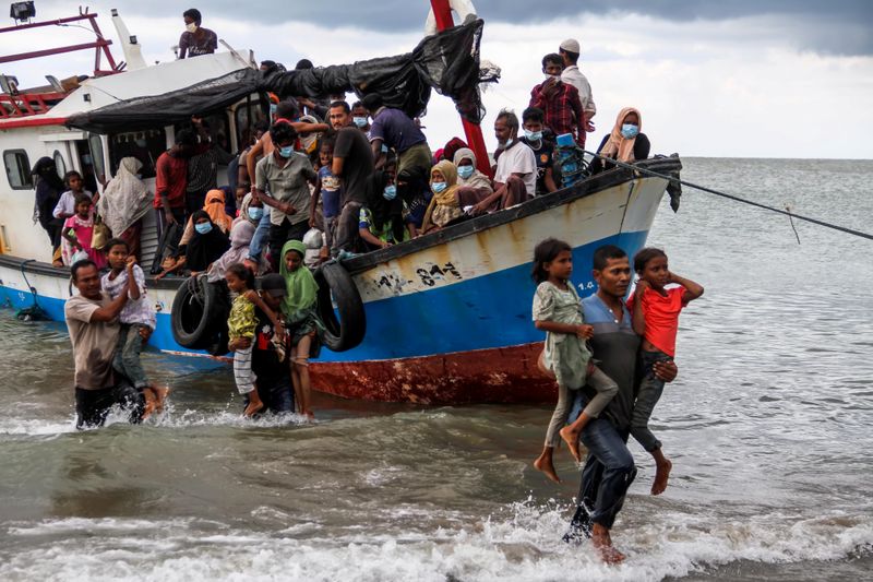 &copy; Reuters. Locals evacuate Rohingya refugees from a boat at a coast of North Aceh