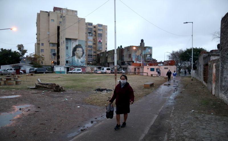 &copy; Reuters. Mulher com máscara de proteção caminha em rua de Fuerte Apache, nos arredores de Buenos Aires, em meio à pandemia de Covid-19