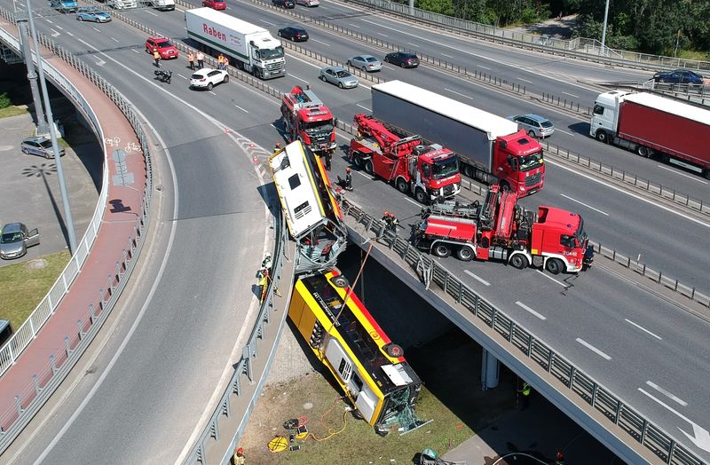 &copy; Reuters. First responders attend to the scene of a public bus crash in Warsaw