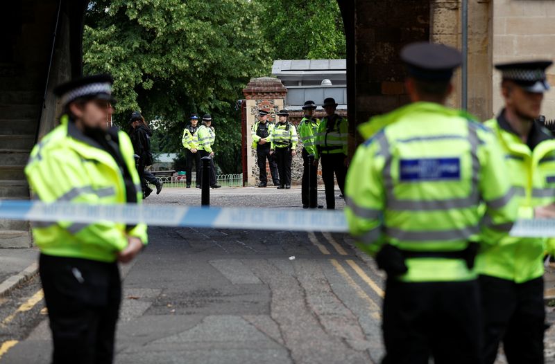 &copy; Reuters. Police officers stand behind the cordon at the scene of multiple stabbings in Reading