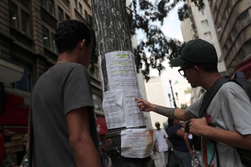 &copy; Reuters. People look at job listings posted on a street in Sao Paulo