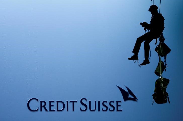 &copy; Reuters. An activist of environmental group Greenpeace is seen beside the logo of of Swiss bank Credit Suisse in Zurich