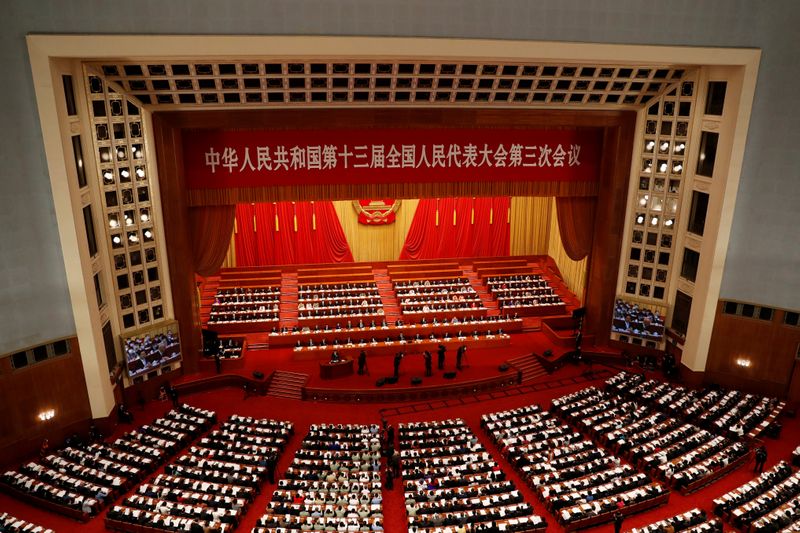 &copy; Reuters. FILE PHOTO: Officials and delegates attend the opening session of NPC in Beijing