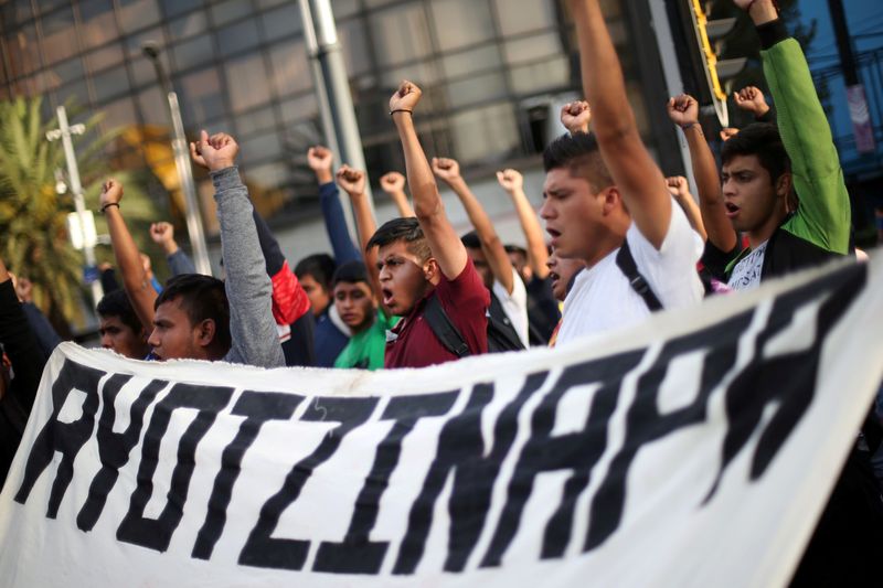 &copy; Reuters. FILE PHOTO: Students participate in a march in Mexico City to mark 65th month since disappearance of the missing Ayotzinapa College Raul Isidro Burgos students in the state of Guerrero
