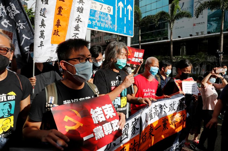 &copy; Reuters. Pro-democracy protesters march during a demonstration near a flag raising ceremony on the anniversary of Hong Kong&apos;s handover to China in Hong Kong