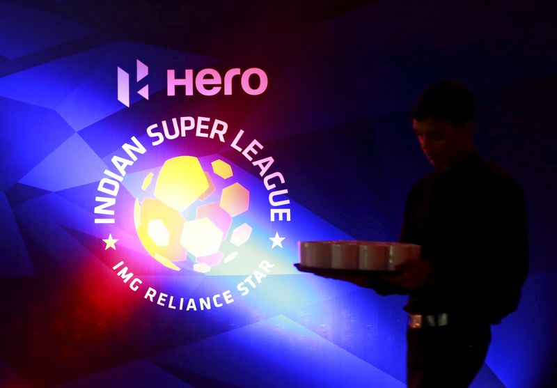 &copy; Reuters. FILE PHOTO: A waiter walks past a logo of Indian Super League before a news conference during the domestic player auction and draft in Mumbai