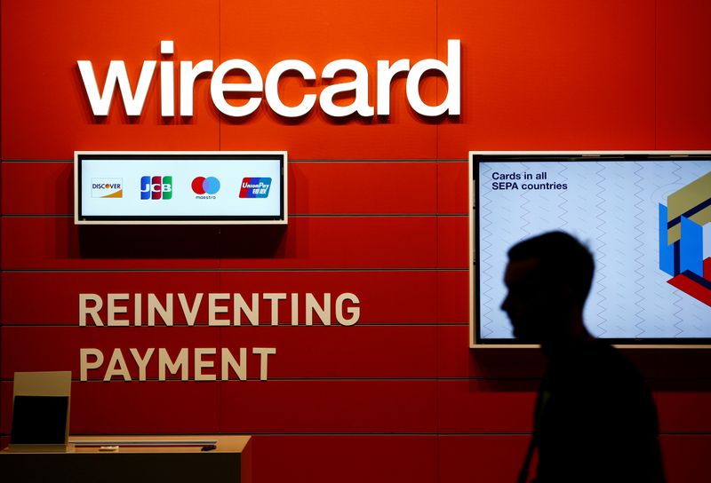 &copy; Reuters. FILE PHOTO: A man walks past the Wirecard booth at the computer games fair Gamescom in Cologne, Germany