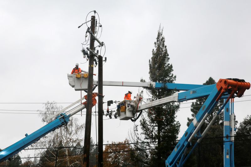 &copy; Reuters. PG&amp;E crew work on power lines to repair damage caused by the Camp Fire in Paradise,
