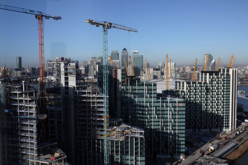 &copy; Reuters. Construction work on the Greenwich Peninsula is seen in front of Canary Wharf financial district in London