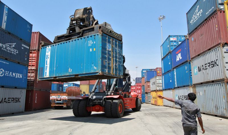 &copy; Reuters. FILE PHOTO: A mobile crane prepares to stack a container at a port in Chennai