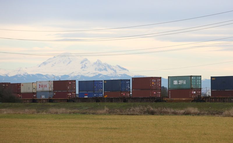 © Reuters. Shipping containers travel on railcars unloaded at Roberts Bank Superport in Delta,