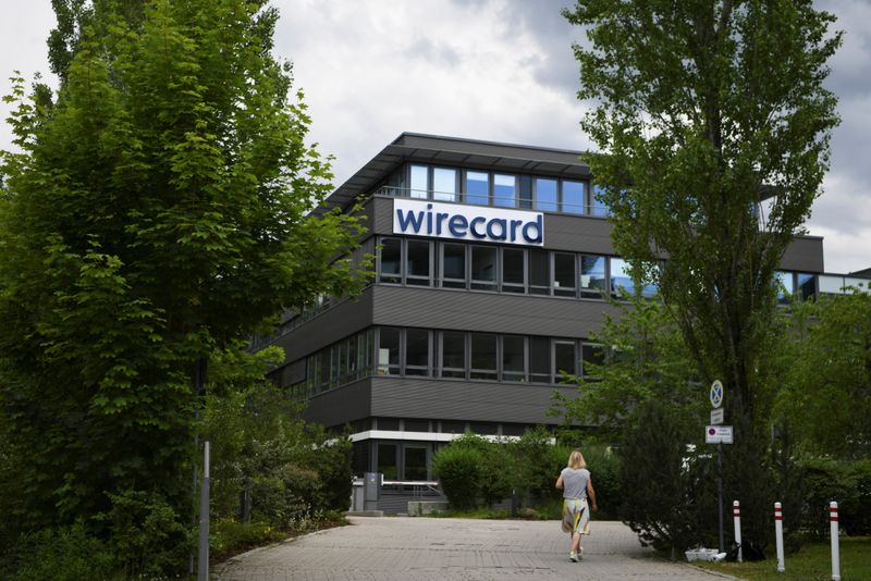 © Reuters. A woman enters the headquarters of Wirecard AG in Aschheim