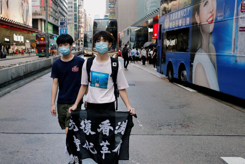 &copy; Reuters. FILE PHOTO: An anti-government protester holds a flag with Chinese calligraphy that reads &quot;Liberate Hong Kong, the revolution of our times&quot;, during a protest at Mong Kok, in Hong Kong