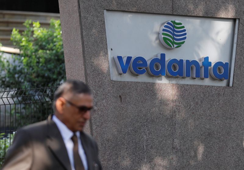 &copy; Reuters. FILE PHOTO: A man walks past the logo of Vedanta outside its headquarters in Mumbai