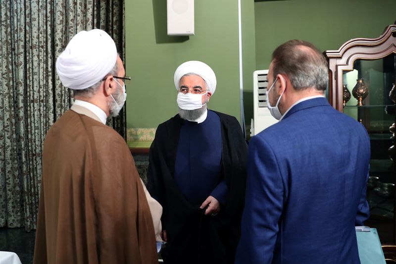 &copy; Reuters. Iranian President Hassan Rouhani is seen wearing a face mask during a meeting, in Tehran