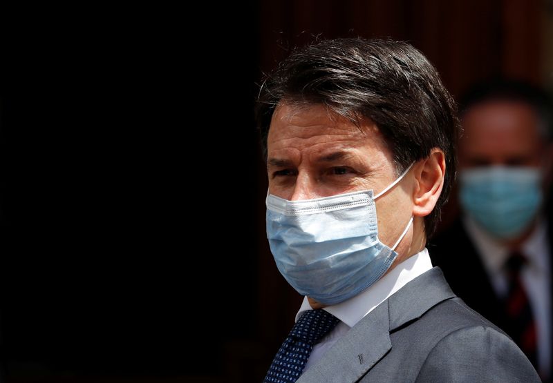 &copy; Reuters. Italian Prime Minister Giuseppe Conte wearing a protective face mask, leaves the Senate as the spread of the coronavirus disease (COVID-19) continues, in Rome