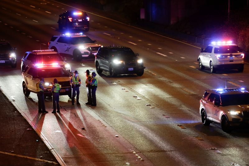 &copy; Reuters. Washington State Patrol investigates the scene where two people in a group of protesters were stuck by a car on Interstate 5, in Seattle
