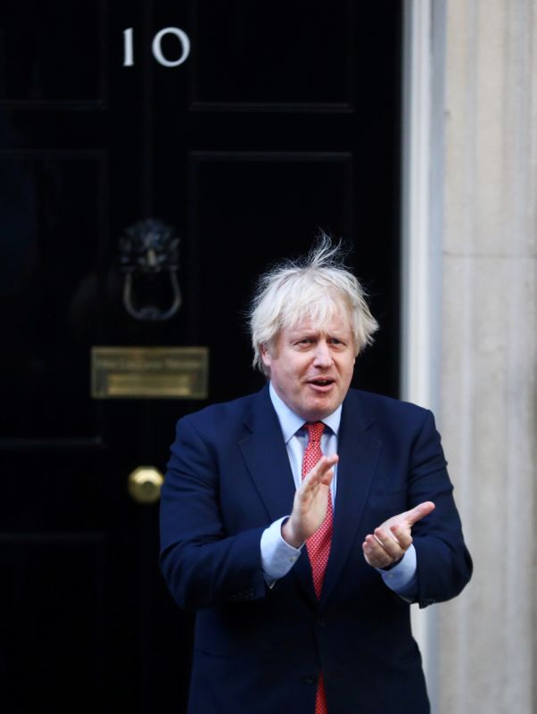 &copy; Reuters. FILE PHOTO: British Prime Minister Boris Johnson applauds the NHS outside 10 Downing Street in May