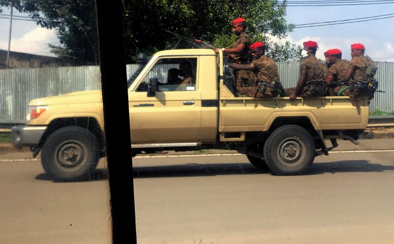 &copy; Reuters. Ethiopian military ride on their pick-up truck as they patrol the streets following protests in Addis Ababa