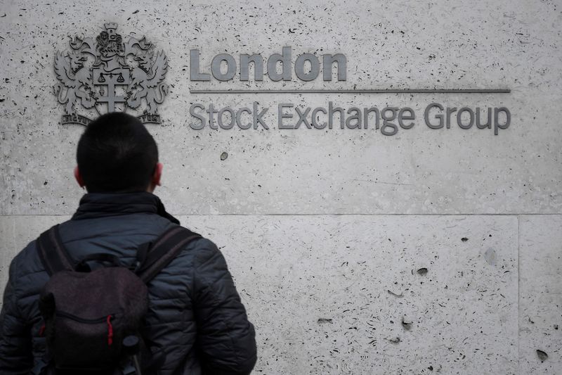 &copy; Reuters. FILE PHOTO: People walk past the London Stock Exchange Group offices in the City of London, Britain