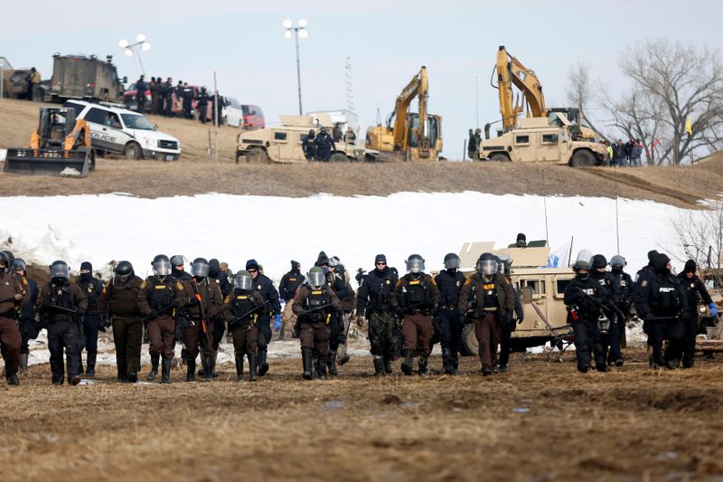 © Reuters. FILE PHOTO: Law enforcement officers advance into the main opposition camp against the Dakota Access oil pipeline near Cannon Ball